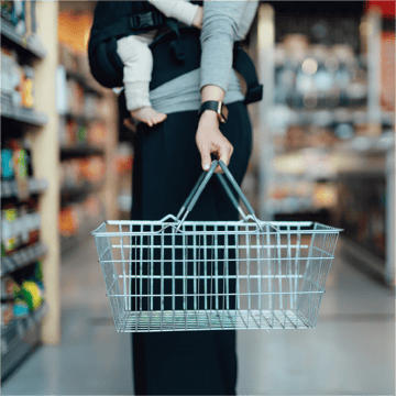 A loyal customer buys groceries through her favorite brand's rewards program powered by embedded banking. 