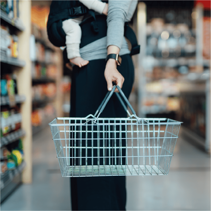 A loyal customer buys groceries through her favorite brand's rewards program powered by embedded banking. 