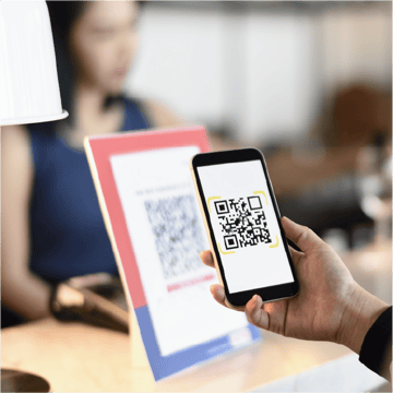 Women using QR code to digitally tip  