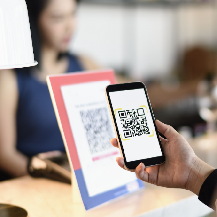 Women using QR code to digitally tip  